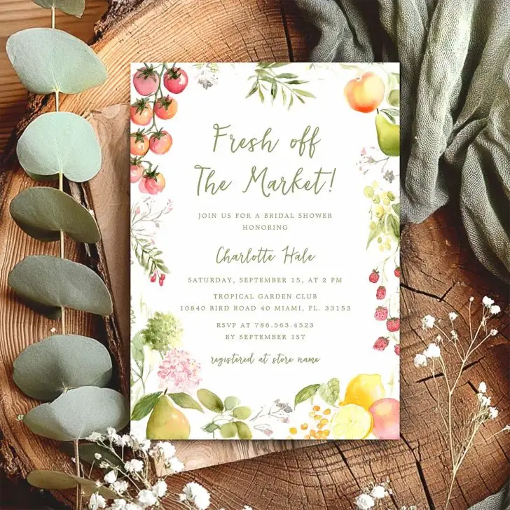 Bridal shower invitation with watercolor fruits and greenery framing the phrase “Fresh off the Market” in sage green script.