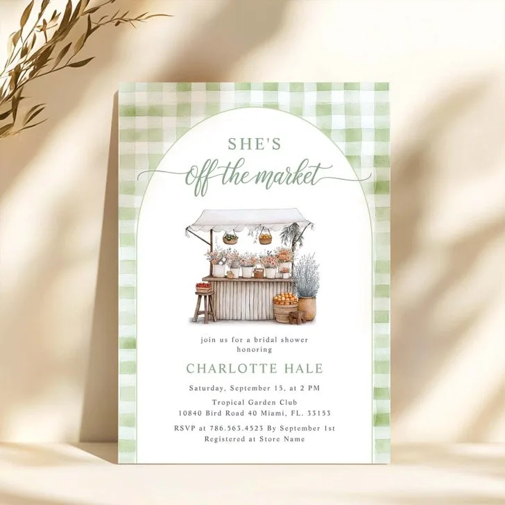 Watercolor invitation with a wooden flower stand, produce, and a green gingham background reading “She’s Off the Market.”